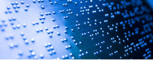 picture of braille imprinted on blue plastic